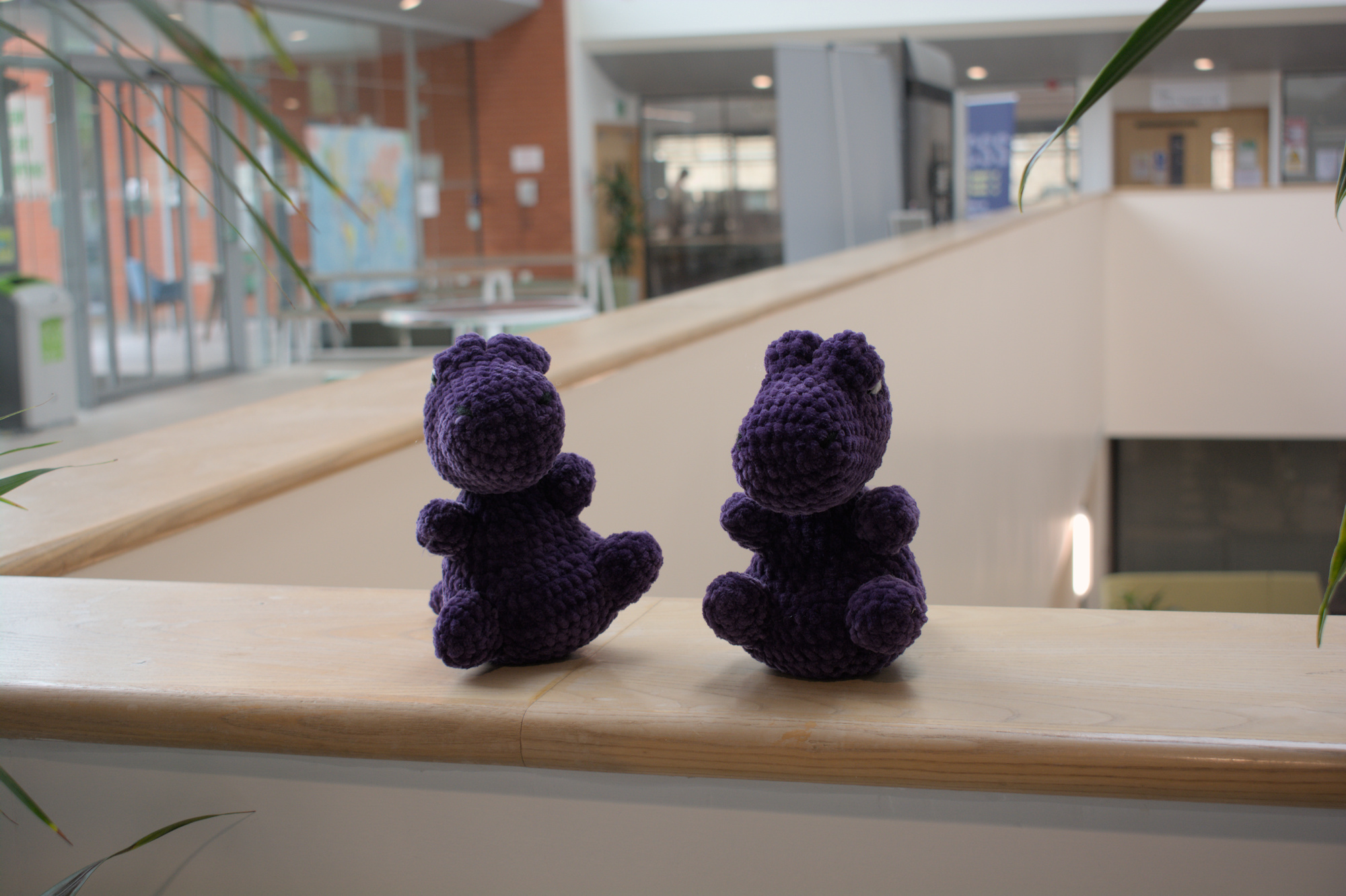 Two TeX plushies on the CS Atrium balcony